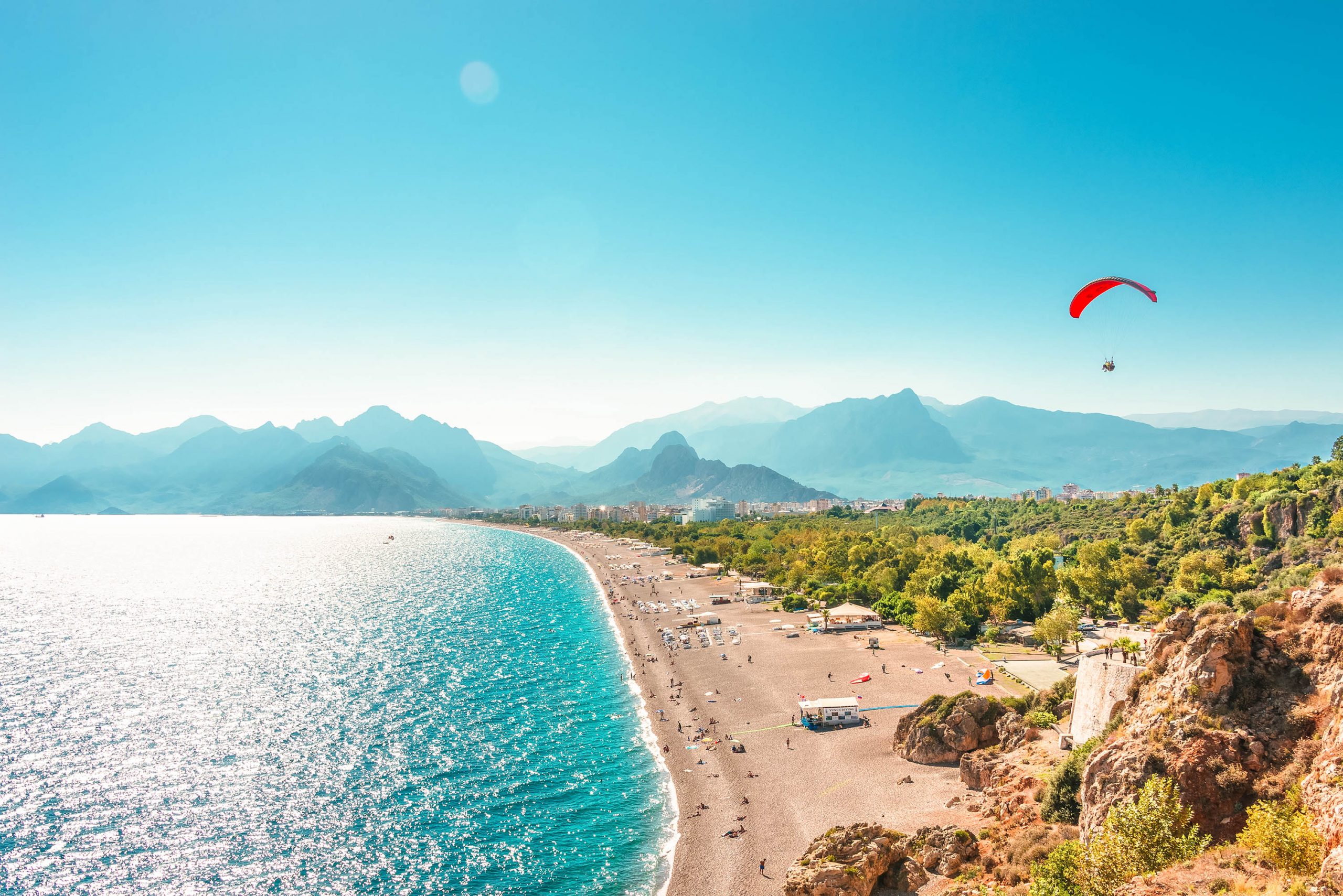 Panoramic bird view of Antalya and Mediterranean seacoast and beach with a paraglider, Antalya, Turkey, Autumn